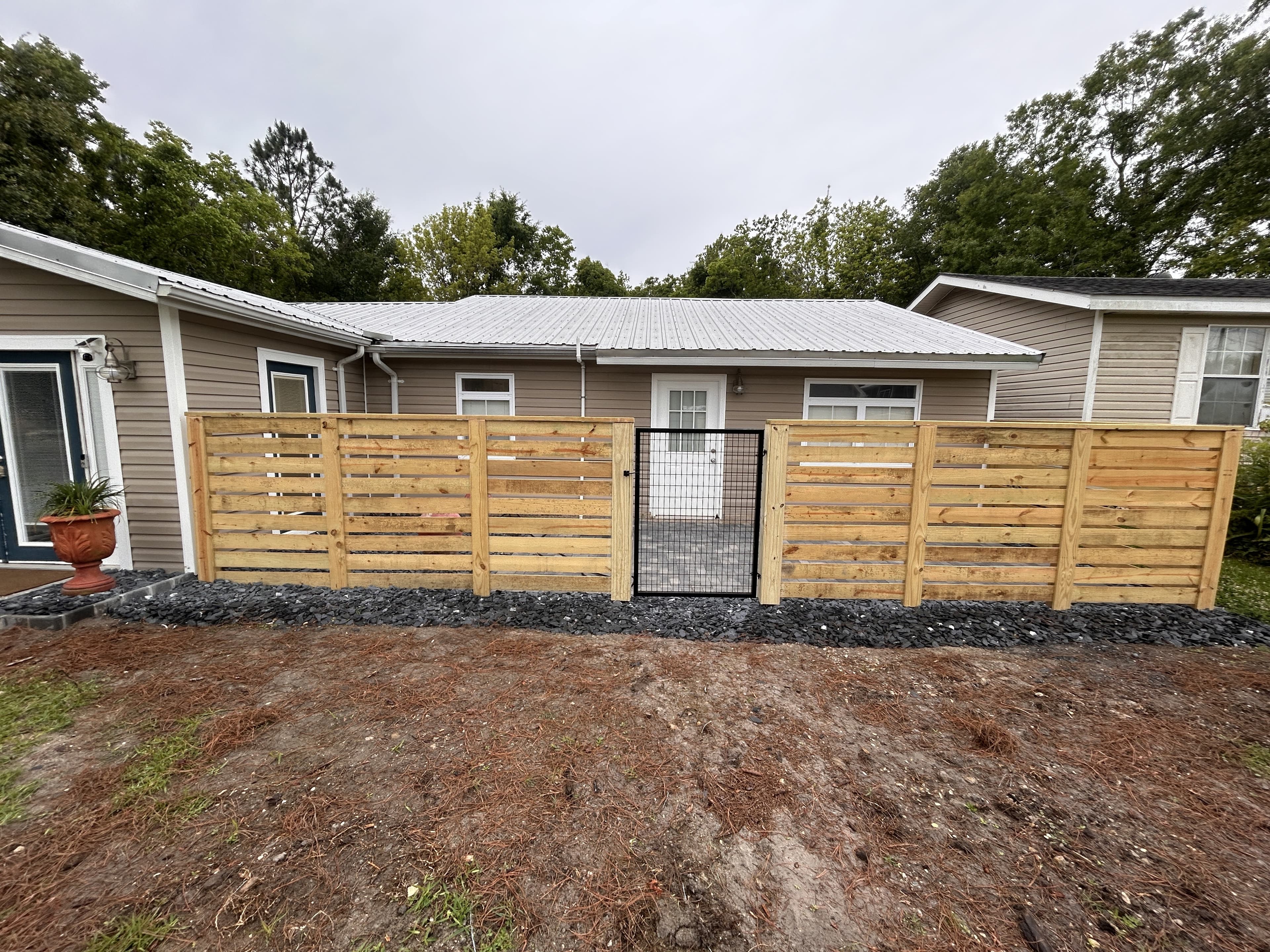Horizontal picket fence with trim and cap